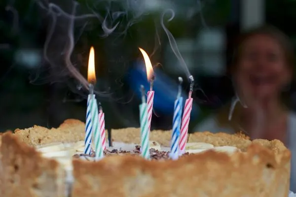 Birthday cake with lit candles at a celebration