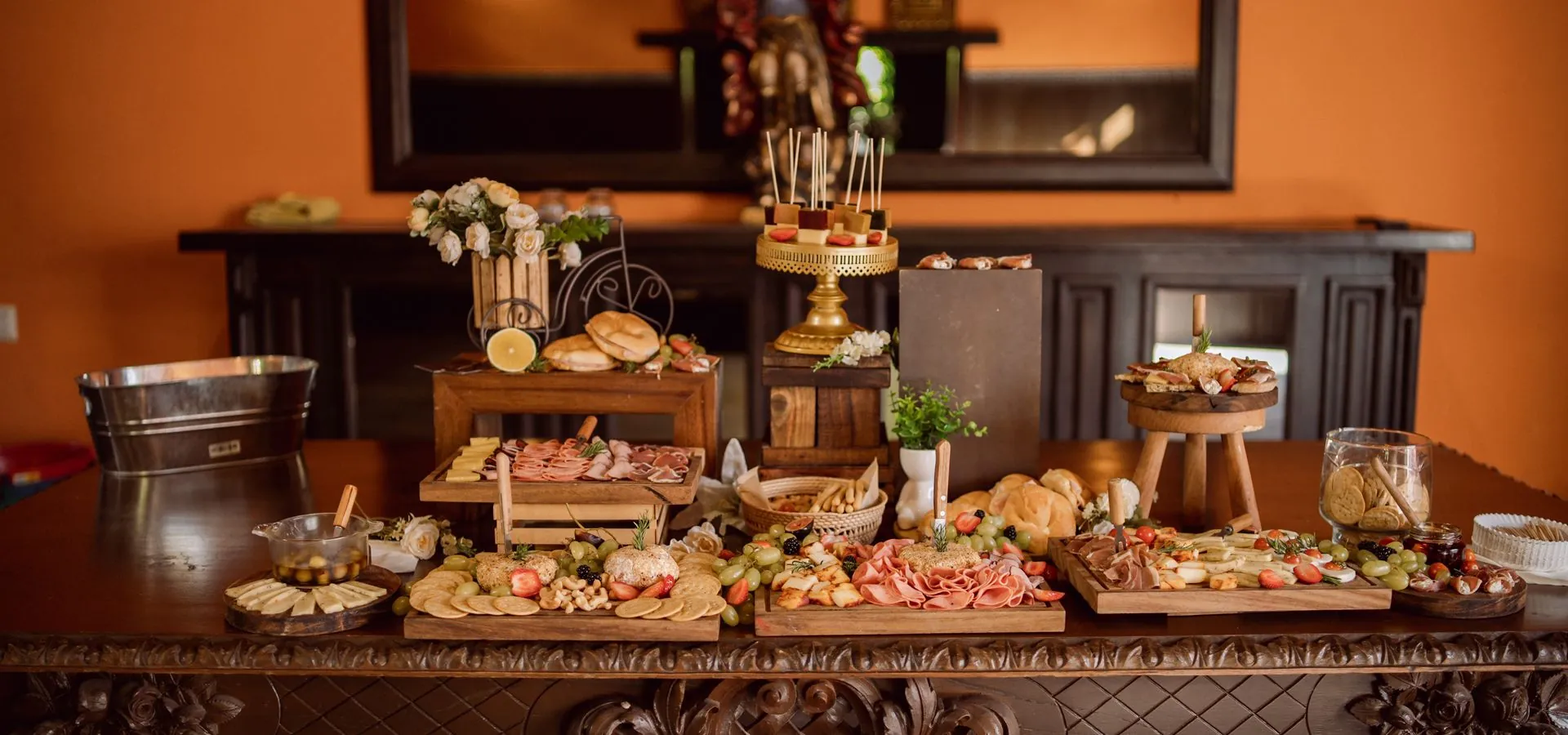 Elegant catering spread with charcuterie, fresh fruits, cheeses, and artisan breads