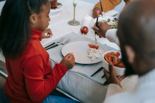 Family gathered around a holiday dinner table sharing a meal