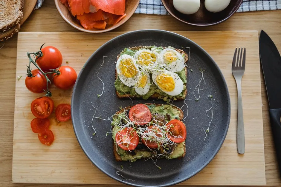 Fresh avocado toast topped with eggs and herbs on a cafe table